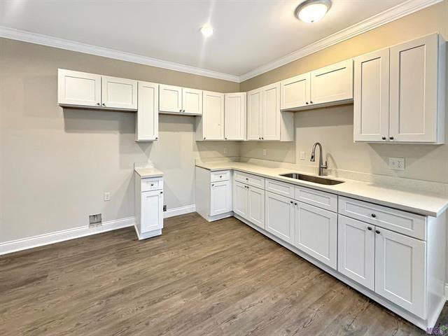 kitchen with white cabinets, dark hardwood / wood-style floors, crown molding, and sink