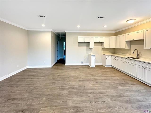 kitchen with white cabinetry, sink, and light wood-type flooring