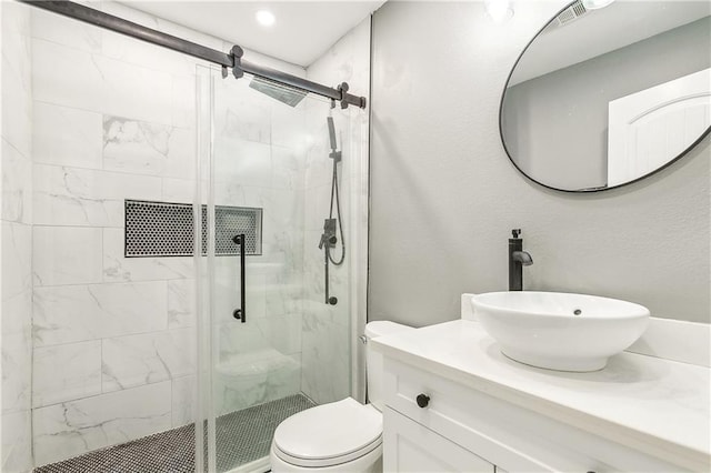 bathroom with vanity, toilet, and an enclosed shower