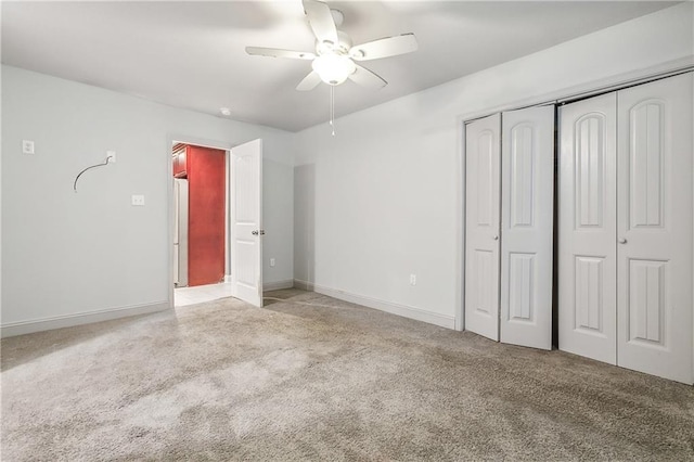 unfurnished bedroom with ceiling fan, a closet, and light colored carpet