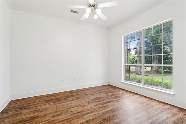 empty room with wood-type flooring, ceiling fan, and crown molding