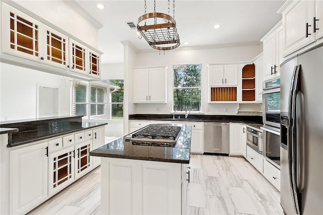 kitchen with white cabinetry, a center island, stainless steel appliances, and decorative light fixtures