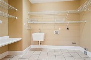 washroom with hookup for an electric dryer, tile patterned floors, and washer hookup