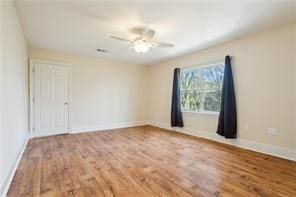 unfurnished room with ceiling fan and wood-type flooring