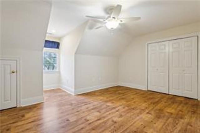 additional living space featuring ceiling fan, hardwood / wood-style floors, and lofted ceiling