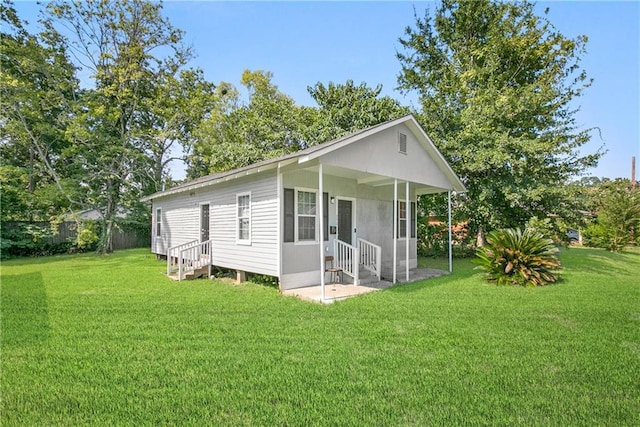 back of house with a lawn