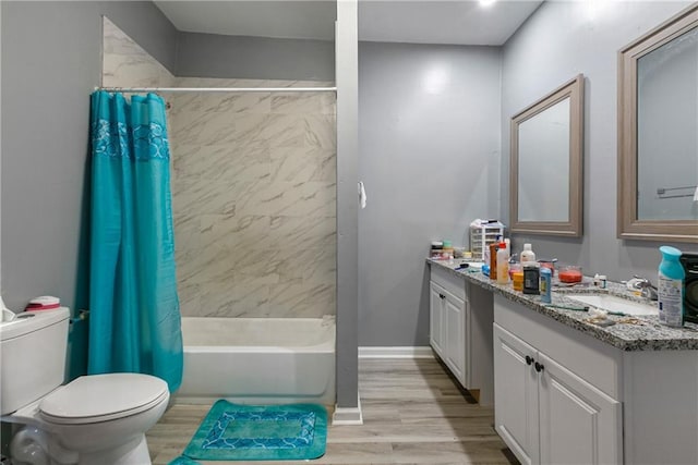 full bathroom with hardwood / wood-style flooring, shower / bath combo, toilet, and vanity