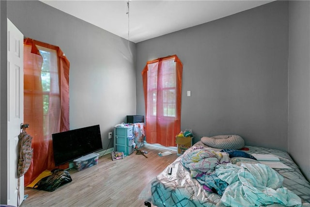 bedroom with hardwood / wood-style floors