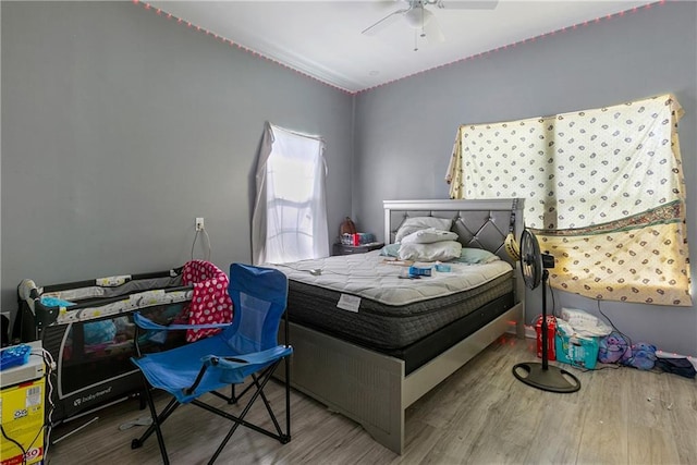 bedroom featuring ceiling fan and hardwood / wood-style floors