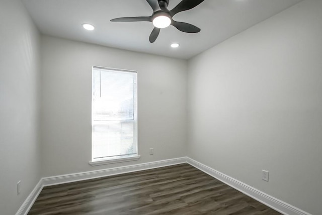 spare room with plenty of natural light, ceiling fan, and dark hardwood / wood-style flooring