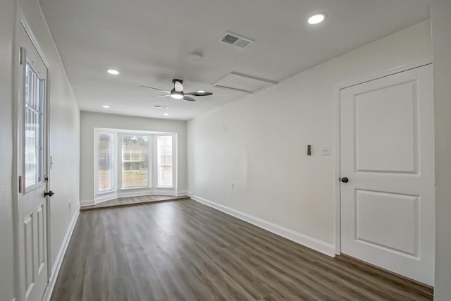 unfurnished room with ceiling fan and dark hardwood / wood-style flooring