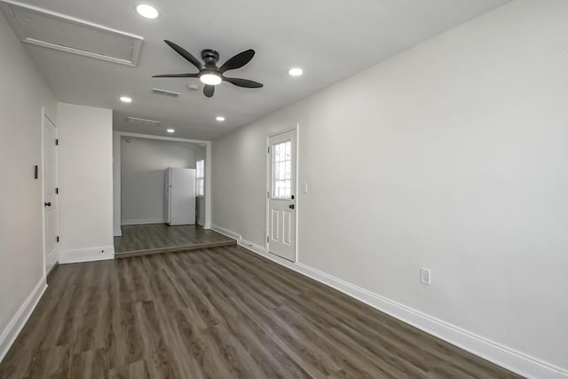 spare room featuring ceiling fan and dark wood-type flooring