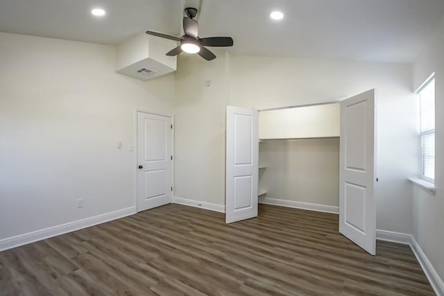 unfurnished bedroom featuring ceiling fan, a closet, high vaulted ceiling, and dark hardwood / wood-style floors