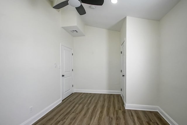 unfurnished room featuring ceiling fan and dark hardwood / wood-style floors