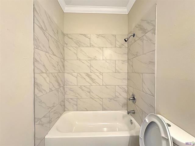 bathroom with toilet, ornamental molding, and tiled shower / bath