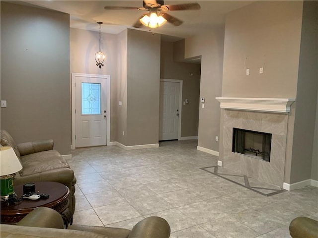 tiled living room featuring ceiling fan and a premium fireplace