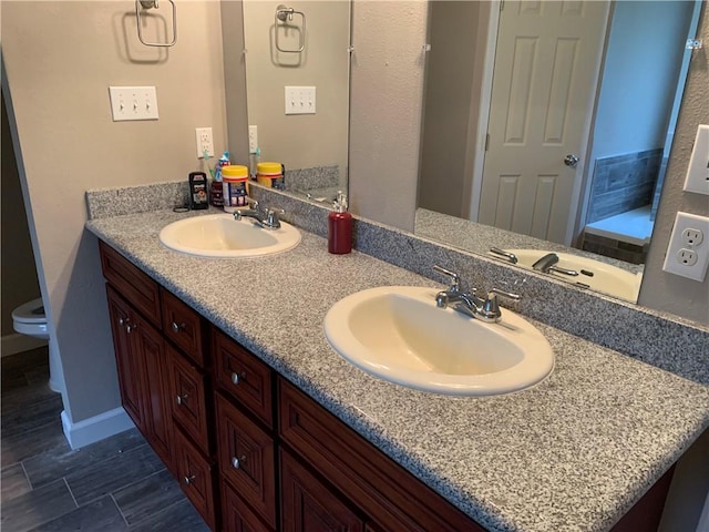 bathroom featuring vanity and toilet