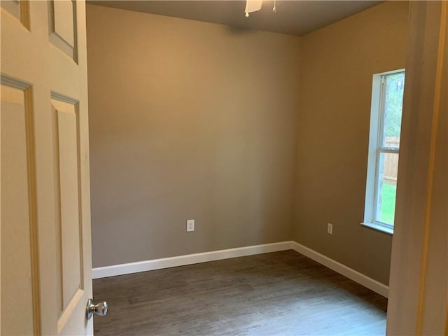 empty room featuring ceiling fan and dark hardwood / wood-style floors