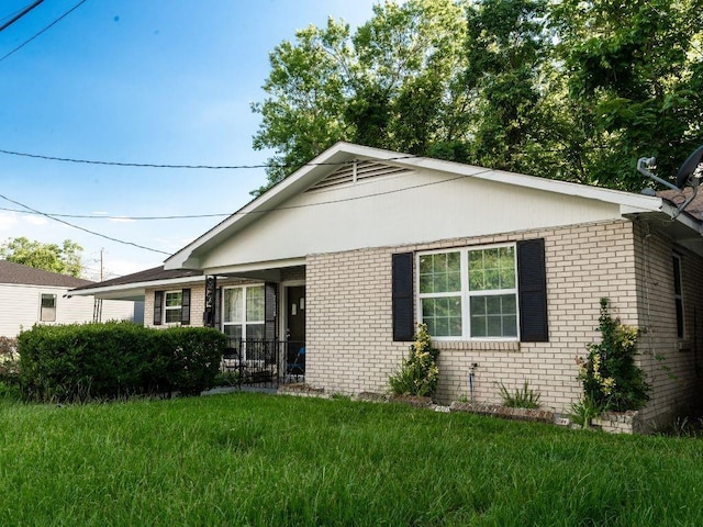 view of side of home with a lawn