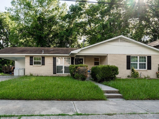 single story home featuring a front lawn and a carport