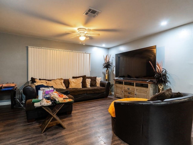 living room featuring ceiling fan and dark wood-type flooring