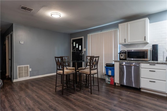 dining area with dark hardwood / wood-style flooring