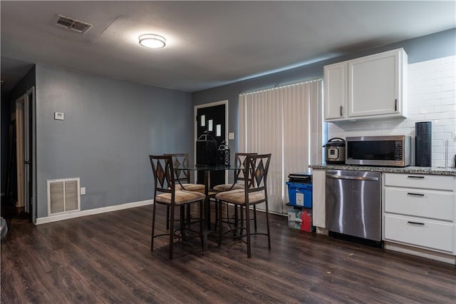2138 Minnesota St, Baton Rouge, LA 70802 - dining space with dark wood-style flooring and baseboards