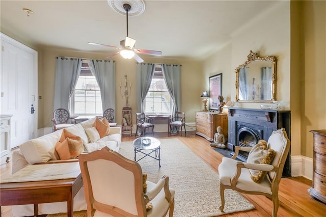 sitting room featuring light hardwood / wood-style floors and ceiling fan