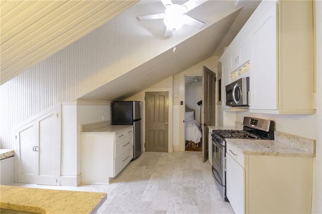 kitchen featuring stainless steel appliances, vaulted ceiling, ceiling fan, light hardwood / wood-style flooring, and white cabinets