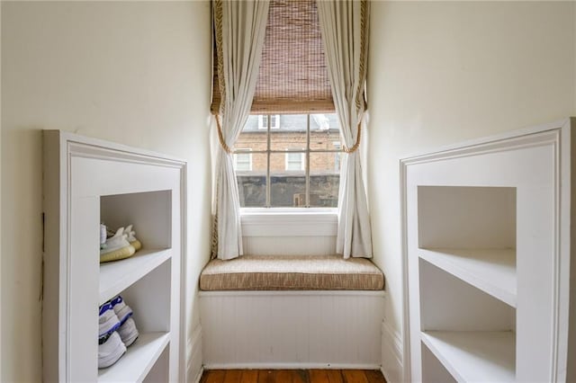 sitting room with hardwood / wood-style floors and built in features