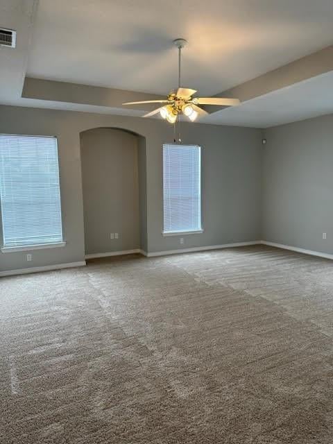 empty room featuring carpet flooring and ceiling fan