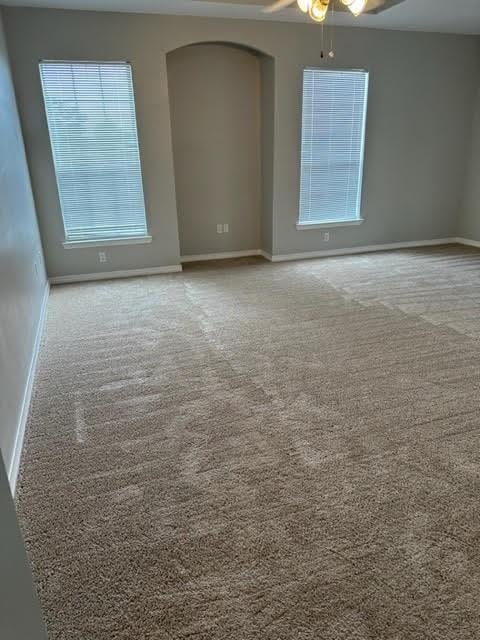 carpeted empty room with ceiling fan