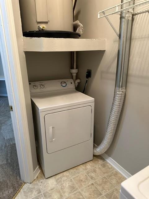 clothes washing area featuring washer / dryer and light tile patterned floors