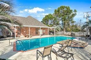 view of swimming pool with a patio area