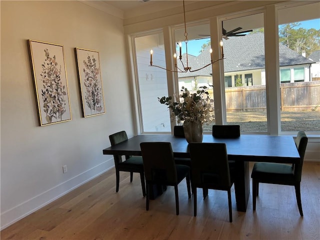 dining area with hardwood / wood-style flooring and a chandelier