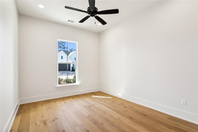 empty room featuring ceiling fan and light hardwood / wood-style flooring