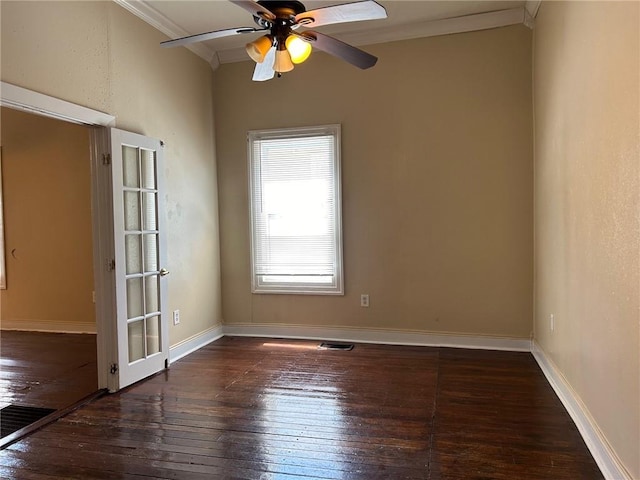 unfurnished room with visible vents, crown molding, baseboards, hardwood / wood-style flooring, and a ceiling fan