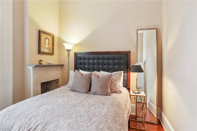 bedroom with hardwood / wood-style flooring