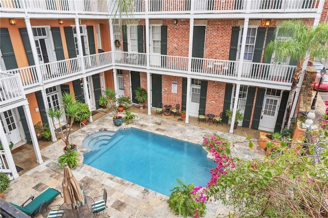 view of swimming pool featuring a patio area