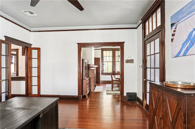 corridor with crown molding, french doors, and dark hardwood / wood-style floors