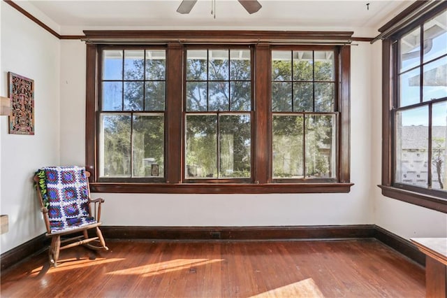 unfurnished sunroom featuring ceiling fan