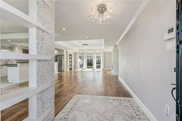 living room featuring hardwood / wood-style floors, an inviting chandelier, and ornamental molding