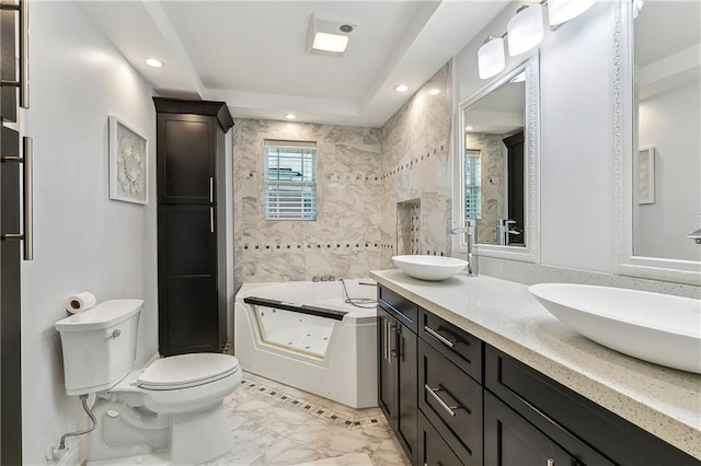 bathroom with a washtub, toilet, tile walls, and vanity