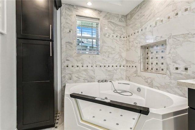 bathroom with a tub and tile walls