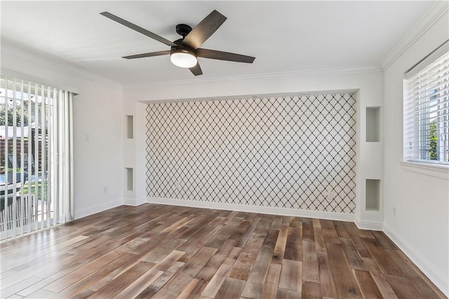 empty room with ceiling fan, dark hardwood / wood-style floors, and ornamental molding