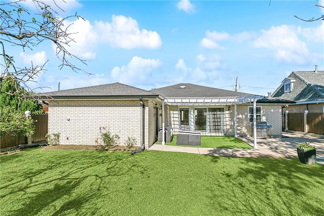 back of house with a yard, a pergola, and a patio