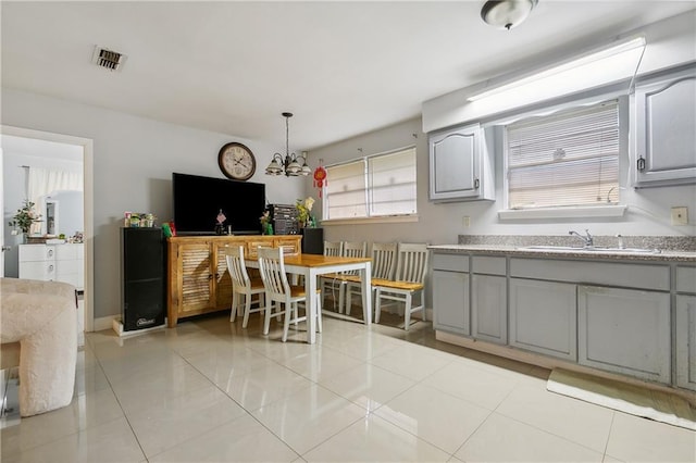 kitchen with pendant lighting, plenty of natural light, and gray cabinets