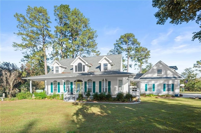 cape cod home with a porch and a front lawn