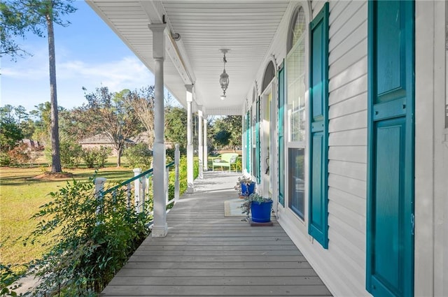 wooden terrace featuring covered porch