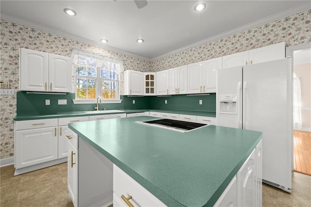 41298 Baytown Rd, Hammond, LA 70403 - kitchen with crown molding, white refrigerator with ice dispenser, white cabinetry, wallpapered walls, and a center island